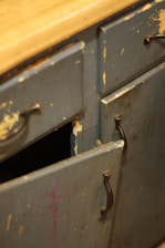 An old metal cabinet with a wooden top
