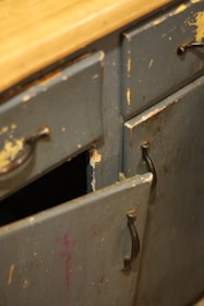 An old metal cabinet with a wooden top