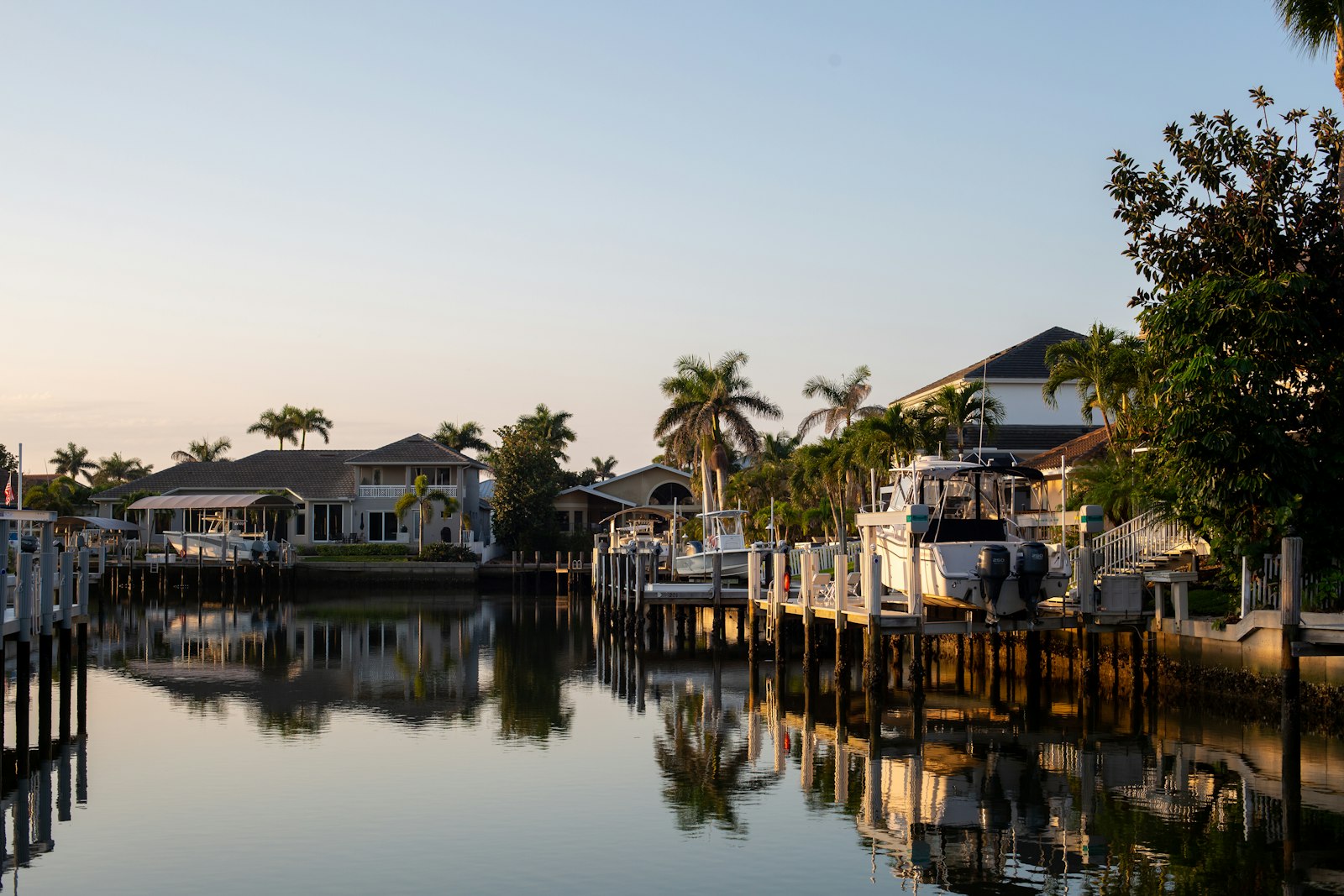 A body of water surrounded by houses and trees.