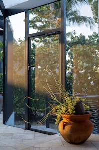 A large vase with a plant inside of it