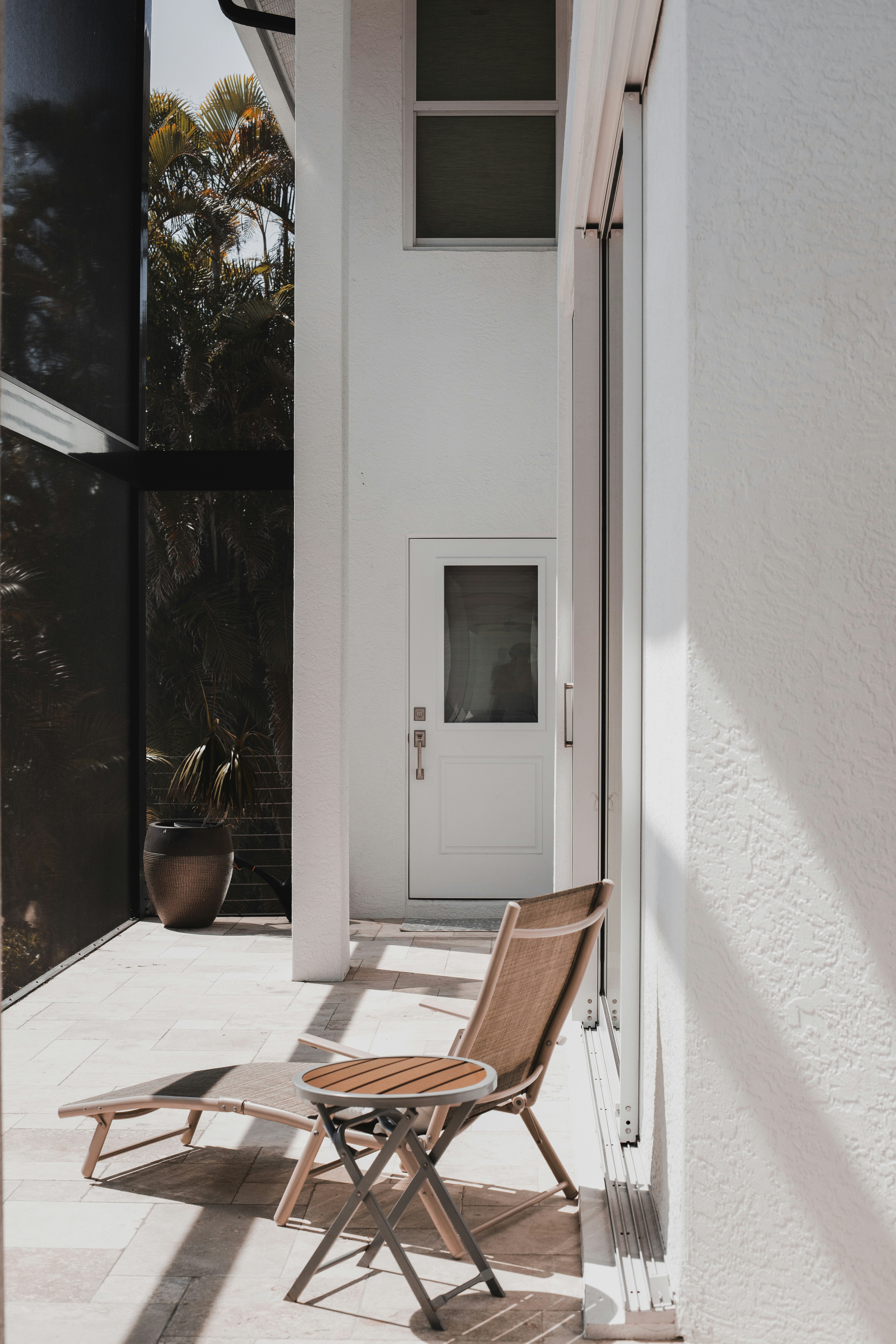 A chair sitting on a patio next to a door