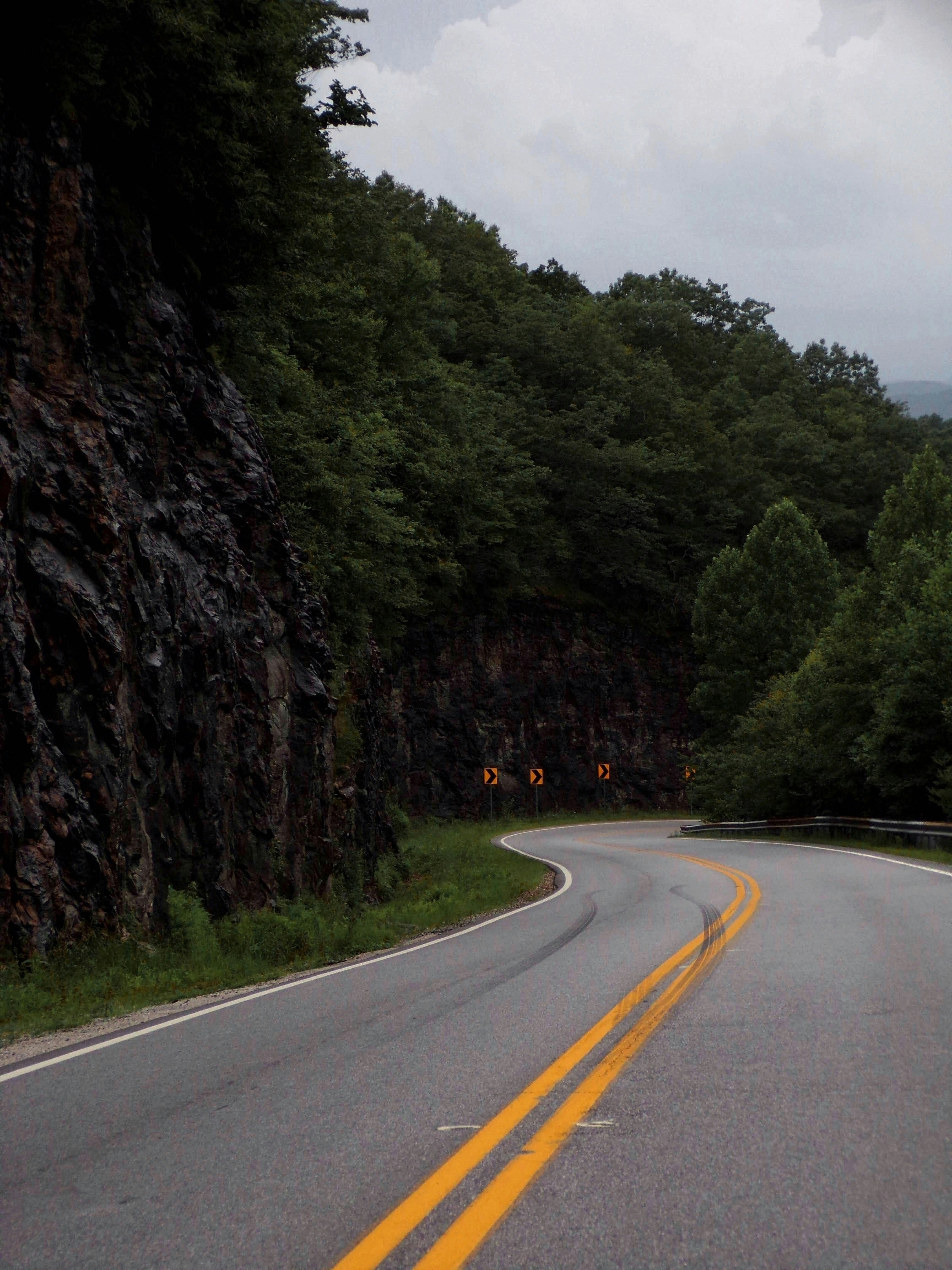 A curve in the road with a mountain in the background