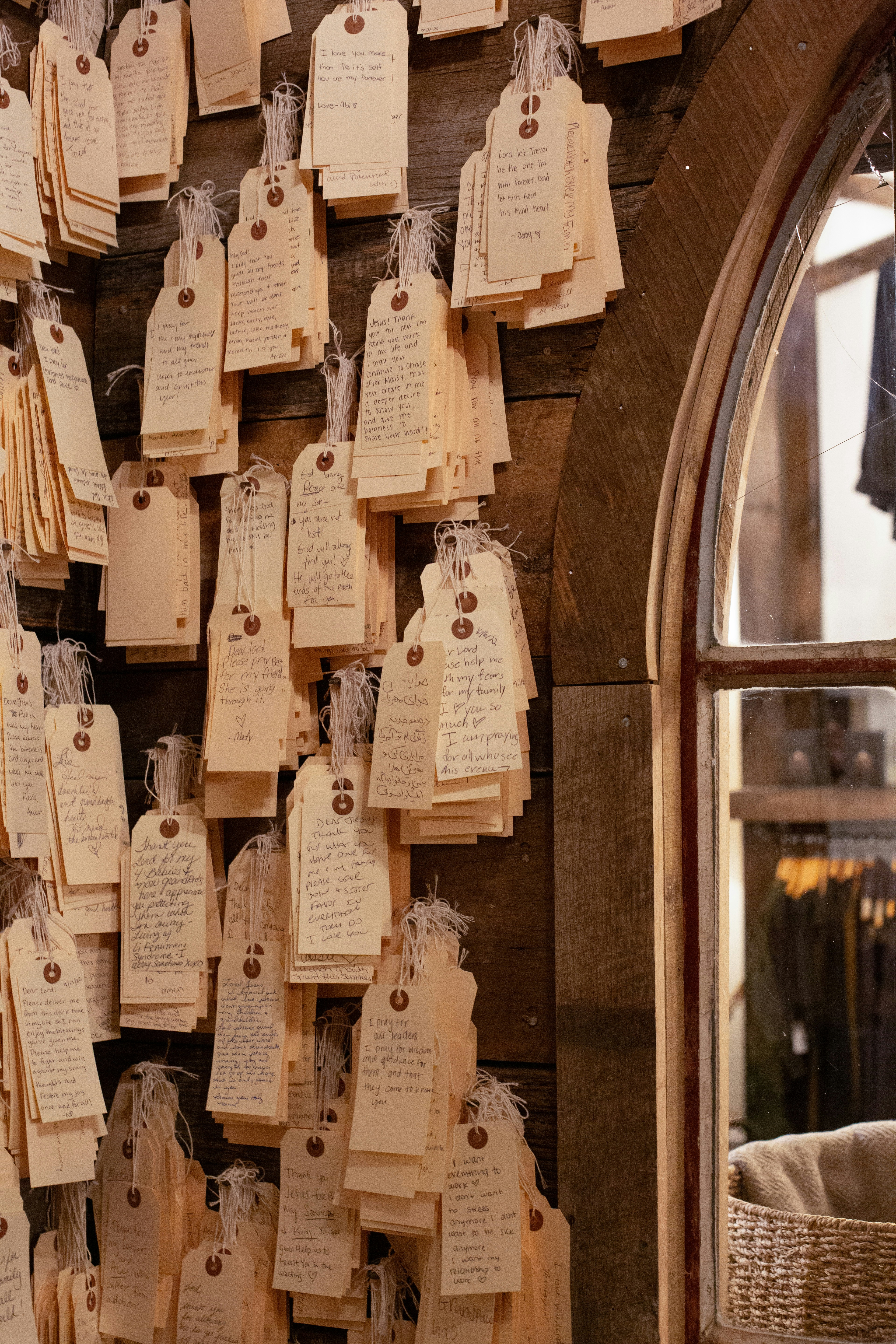A bunch of tags are hanging on a wall
