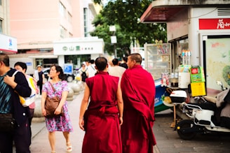 A group of people walking down a street