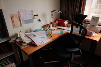 A desk with a chair and a laptop on it