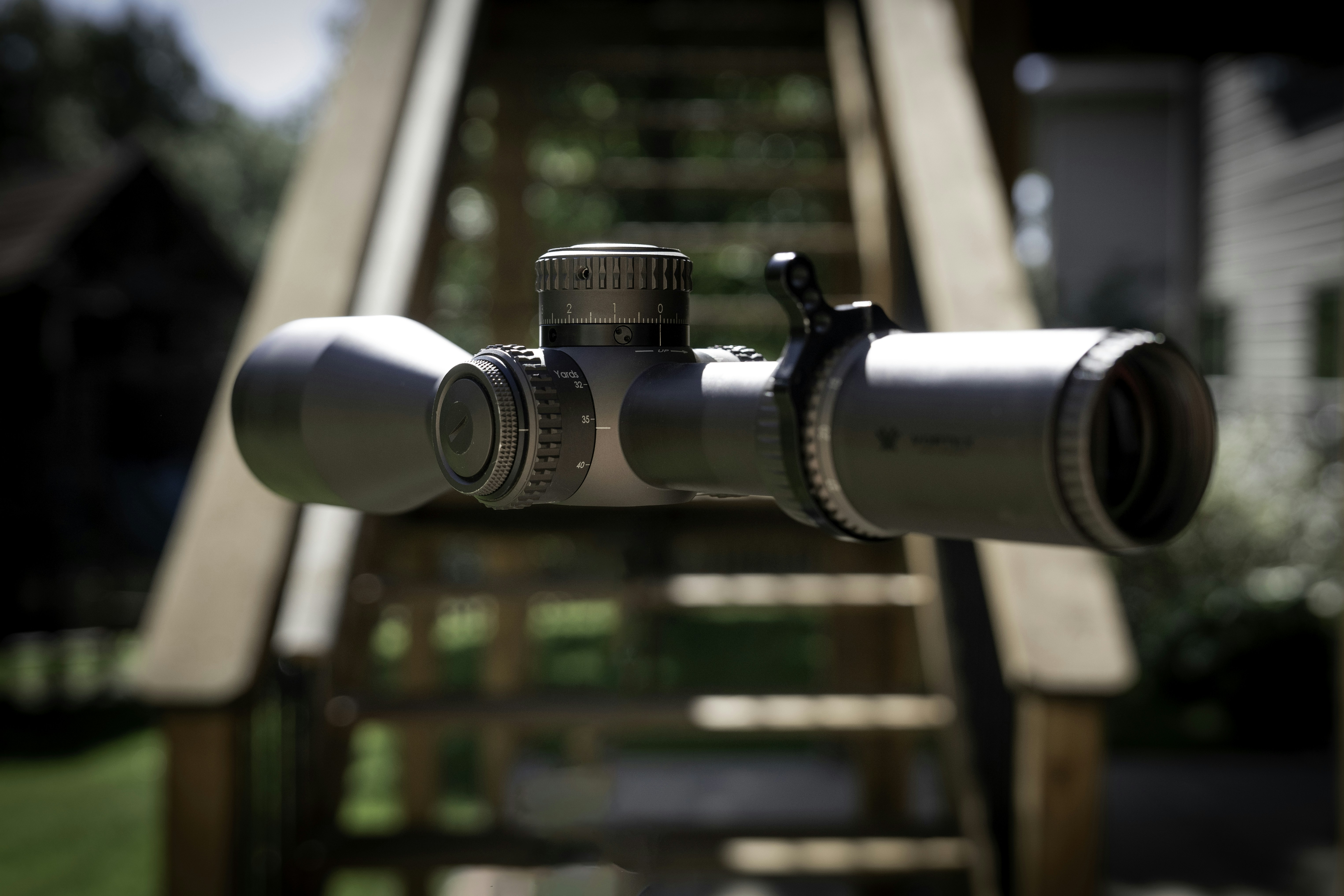 A pair of binoculars sitting on top of a wooden bench