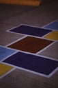 A skateboard is sitting on the ground painted with squares
