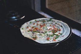 A pizza sitting on top of a stove top oven