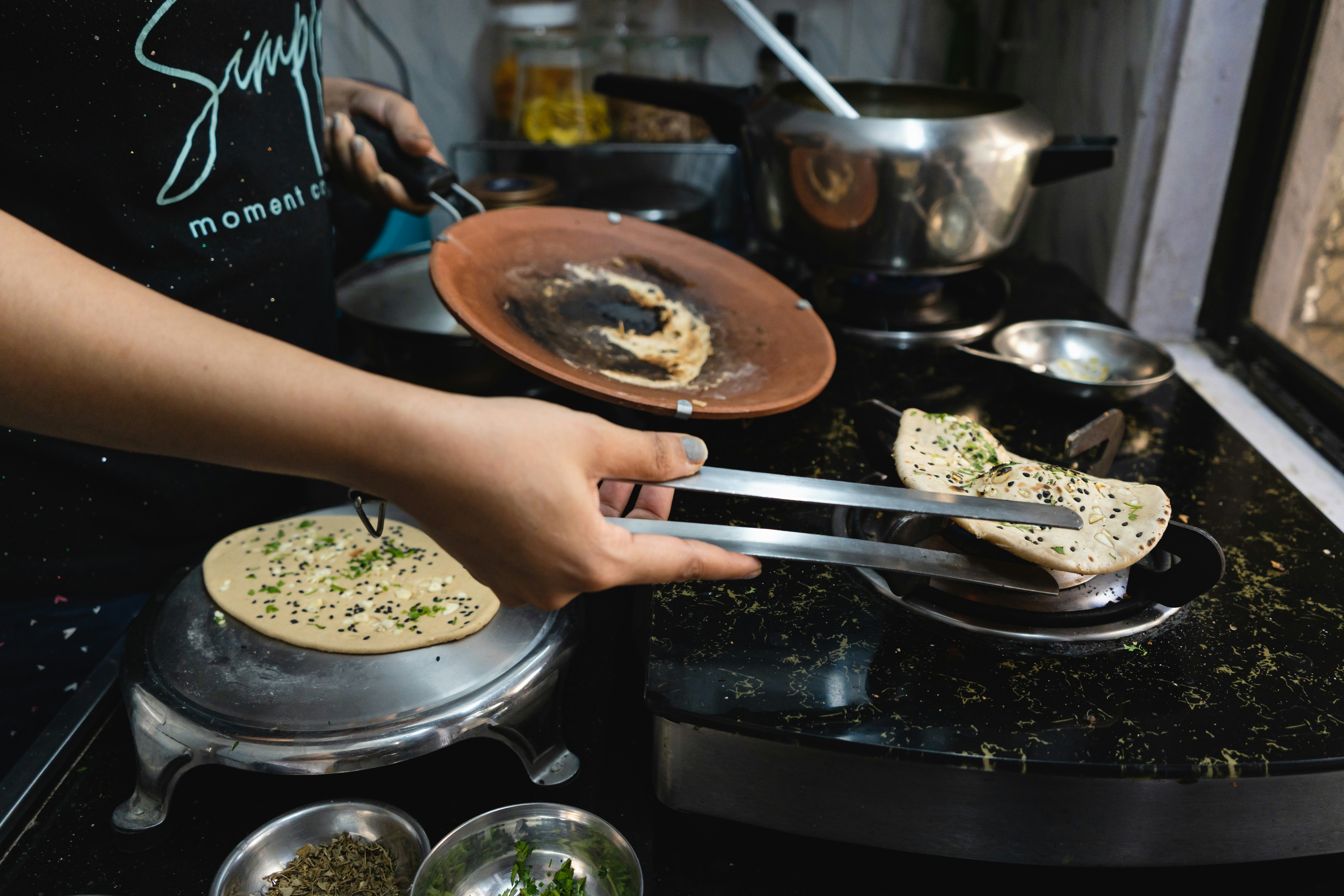 A person cooking food on top of a stove