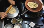 A person cooking food on top of a stove
