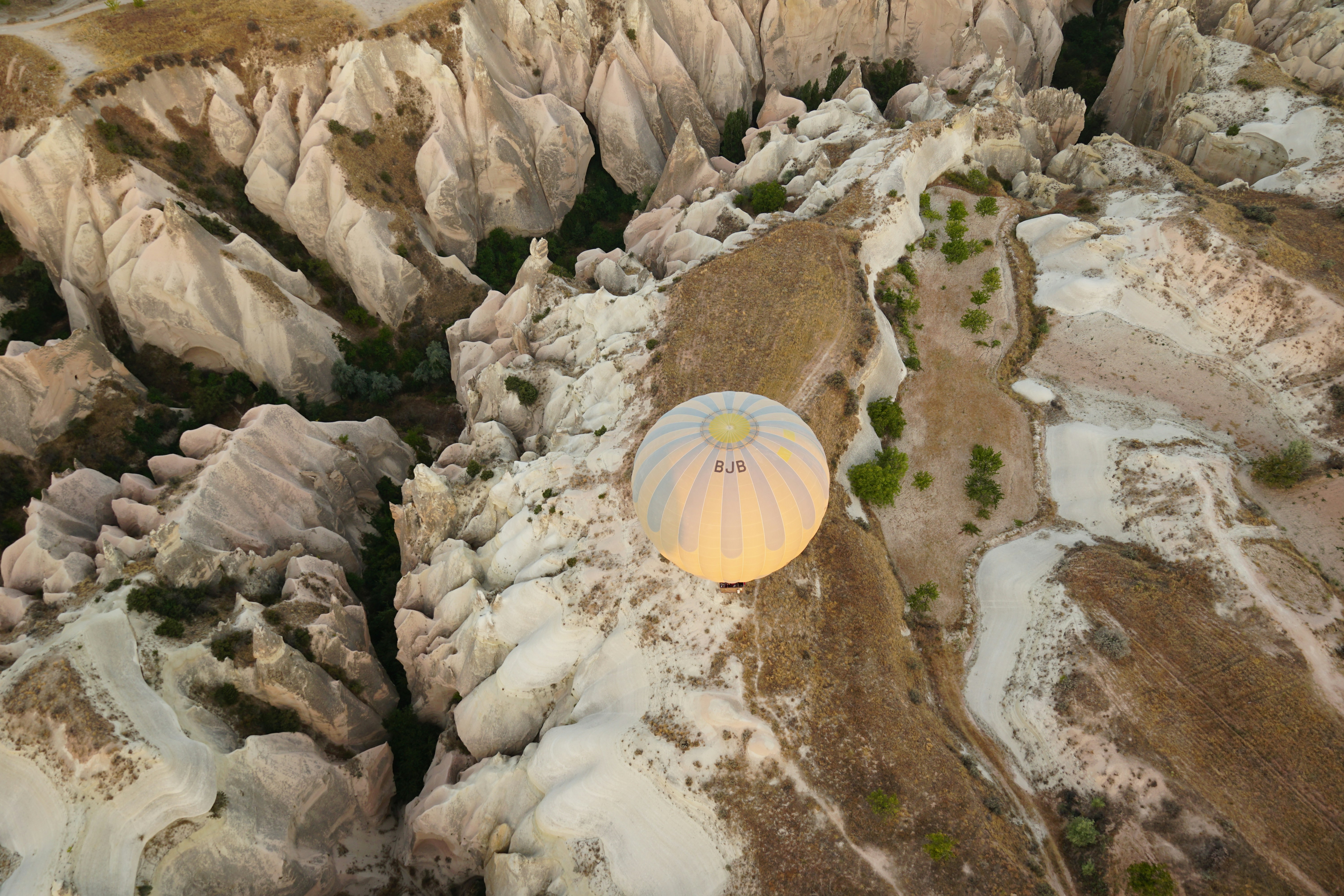 An aerial view of a mountain with a satellite dish