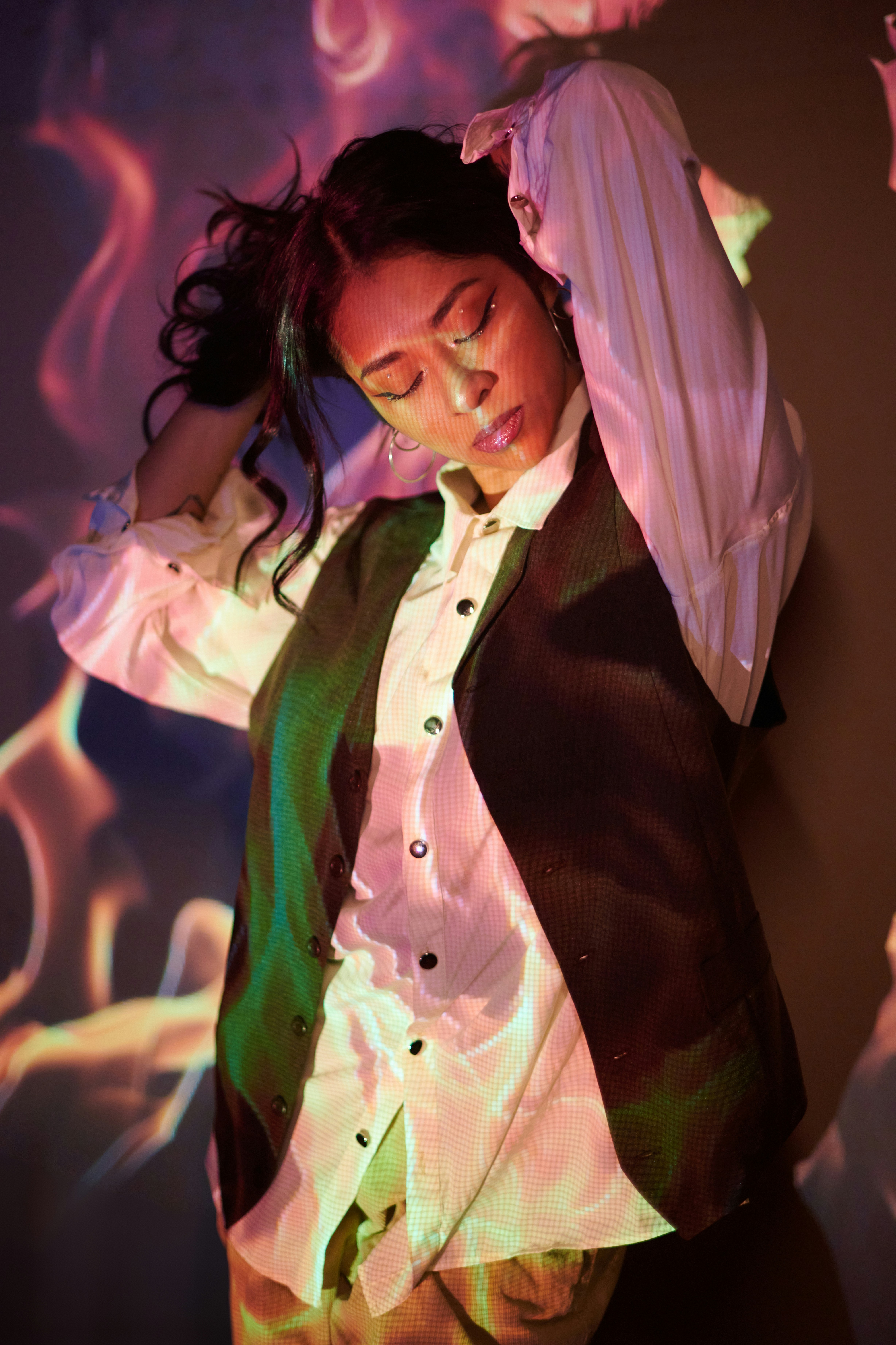 A woman in a suit and tie posing for a picture