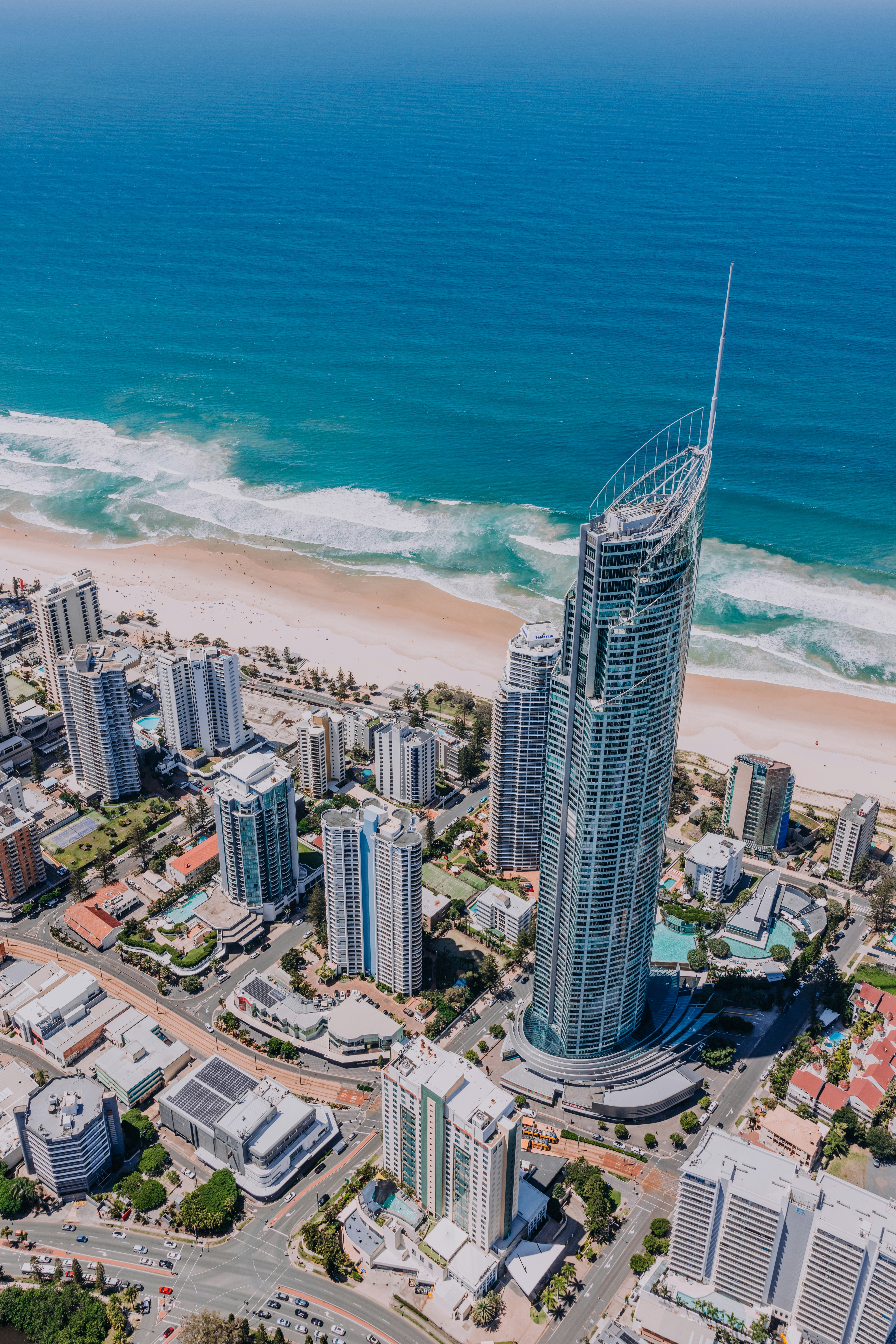 An aerial view of a city with a beach in the background