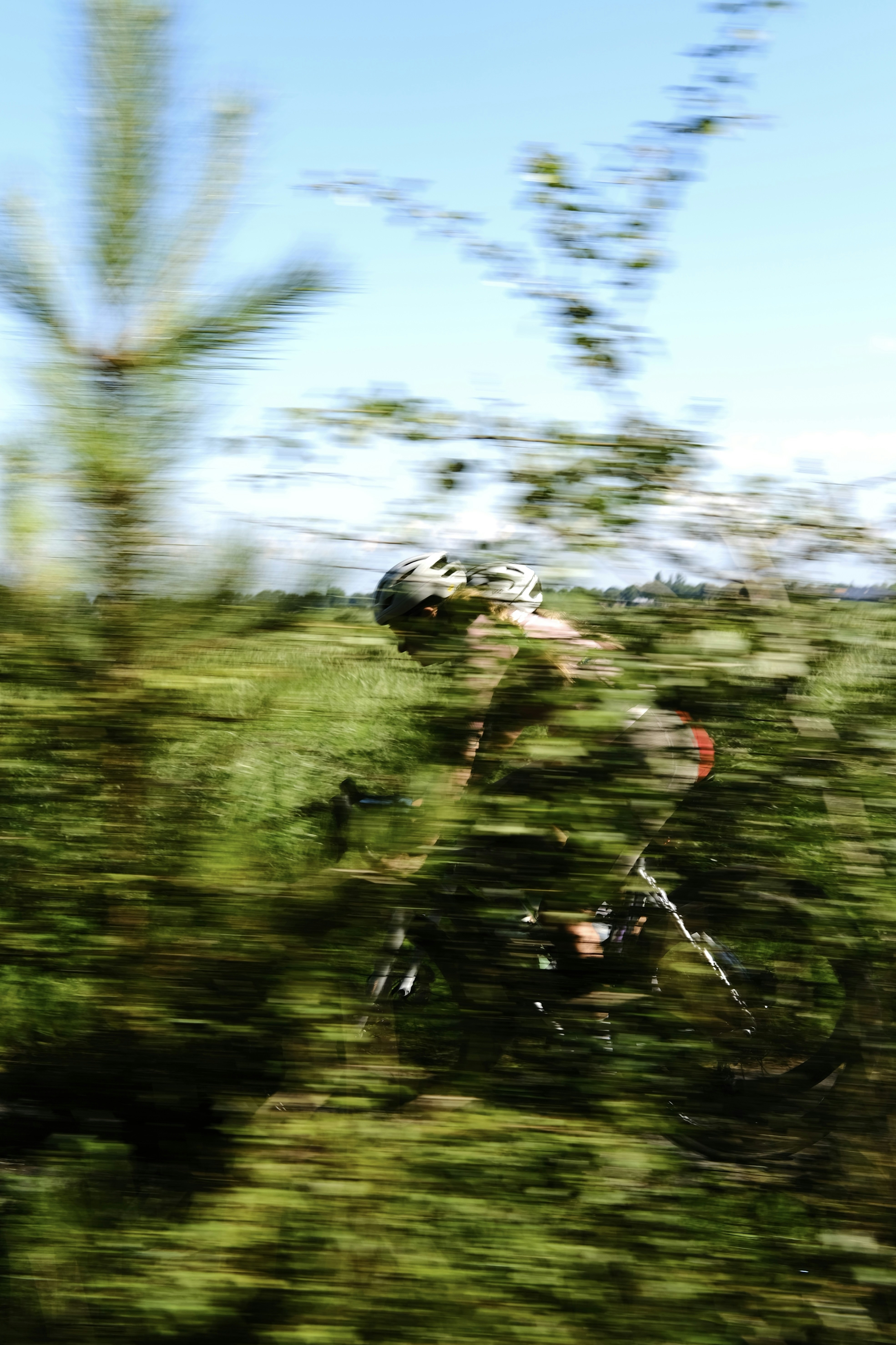 A blurry photo of a person riding a bike