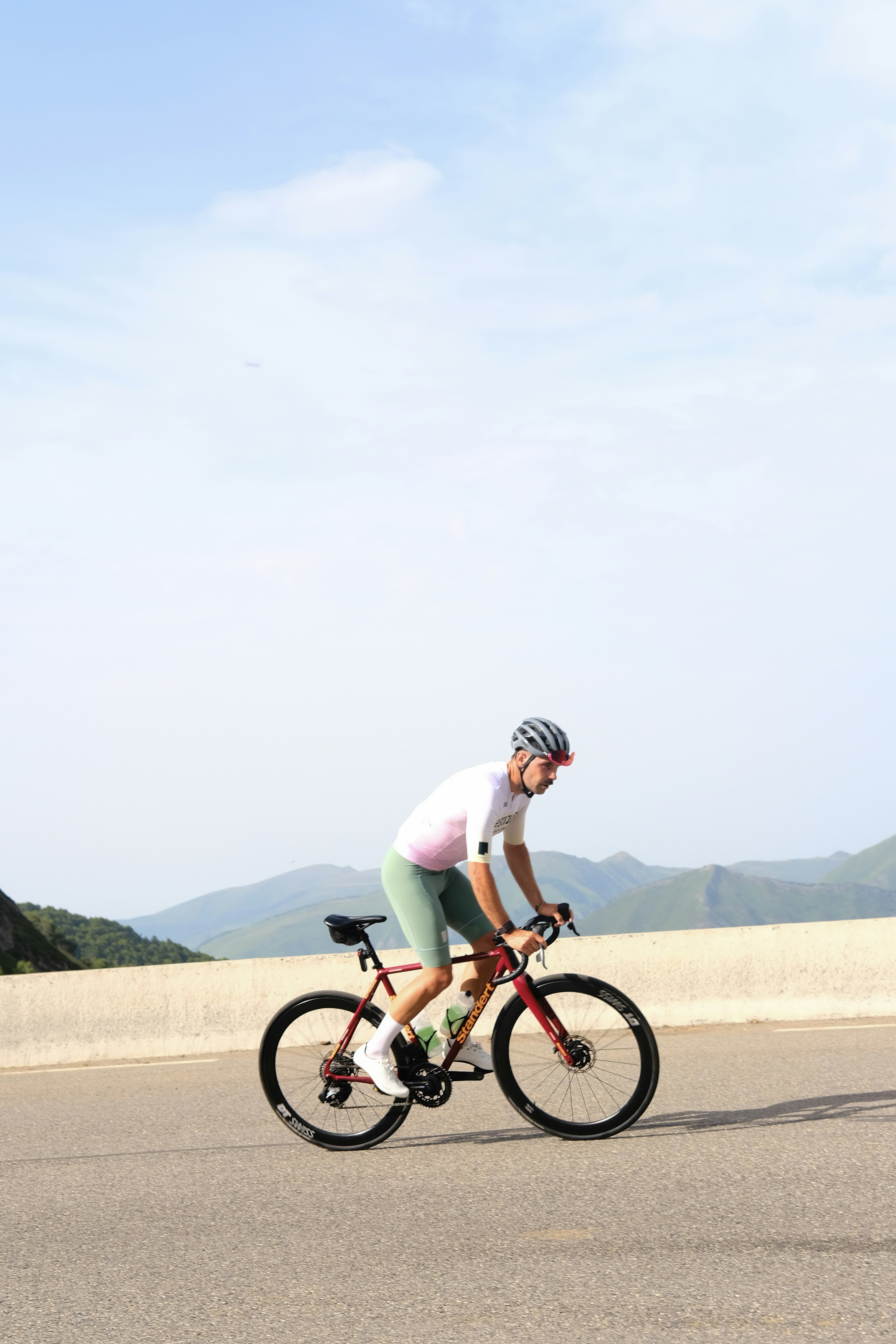 A man riding a bike down a road