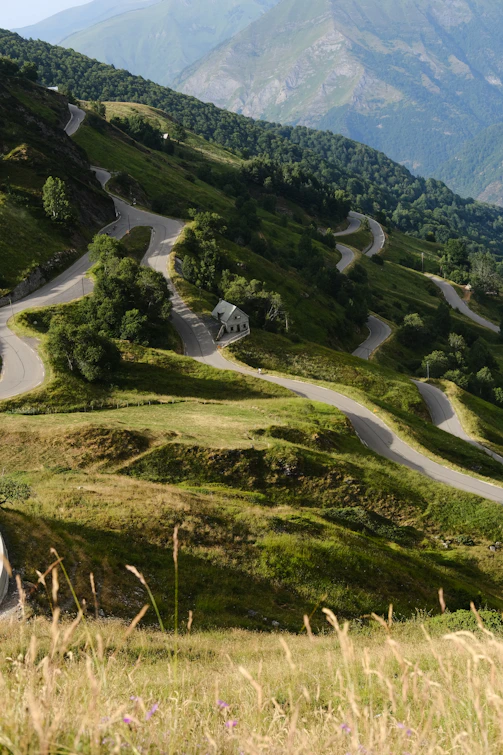 A car driving down a winding road in the mountains