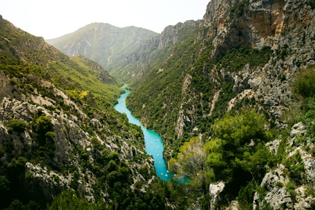 A river flowing through a valley surrounded by mountains
