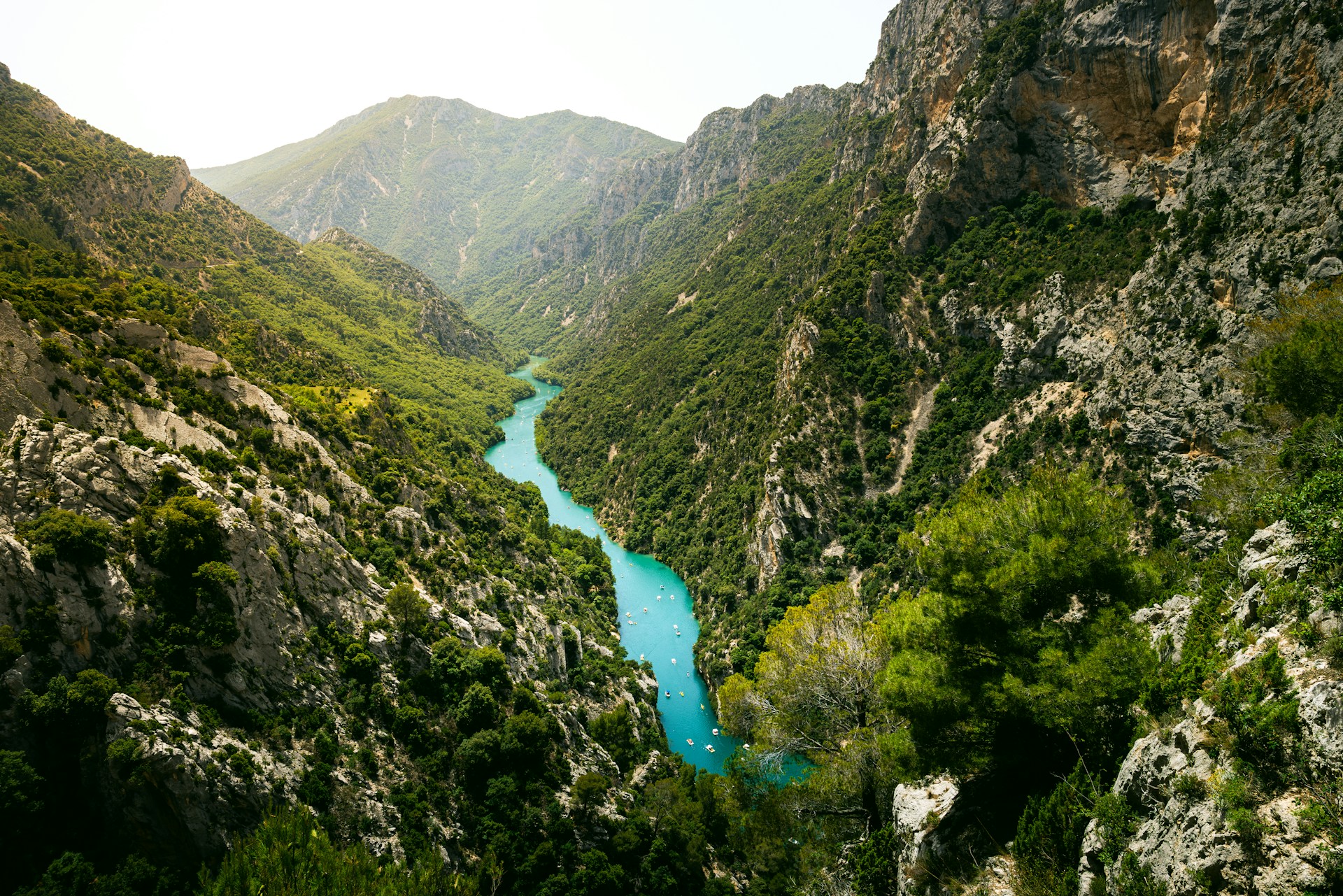 A river flowing through a valley surrounded by mountains