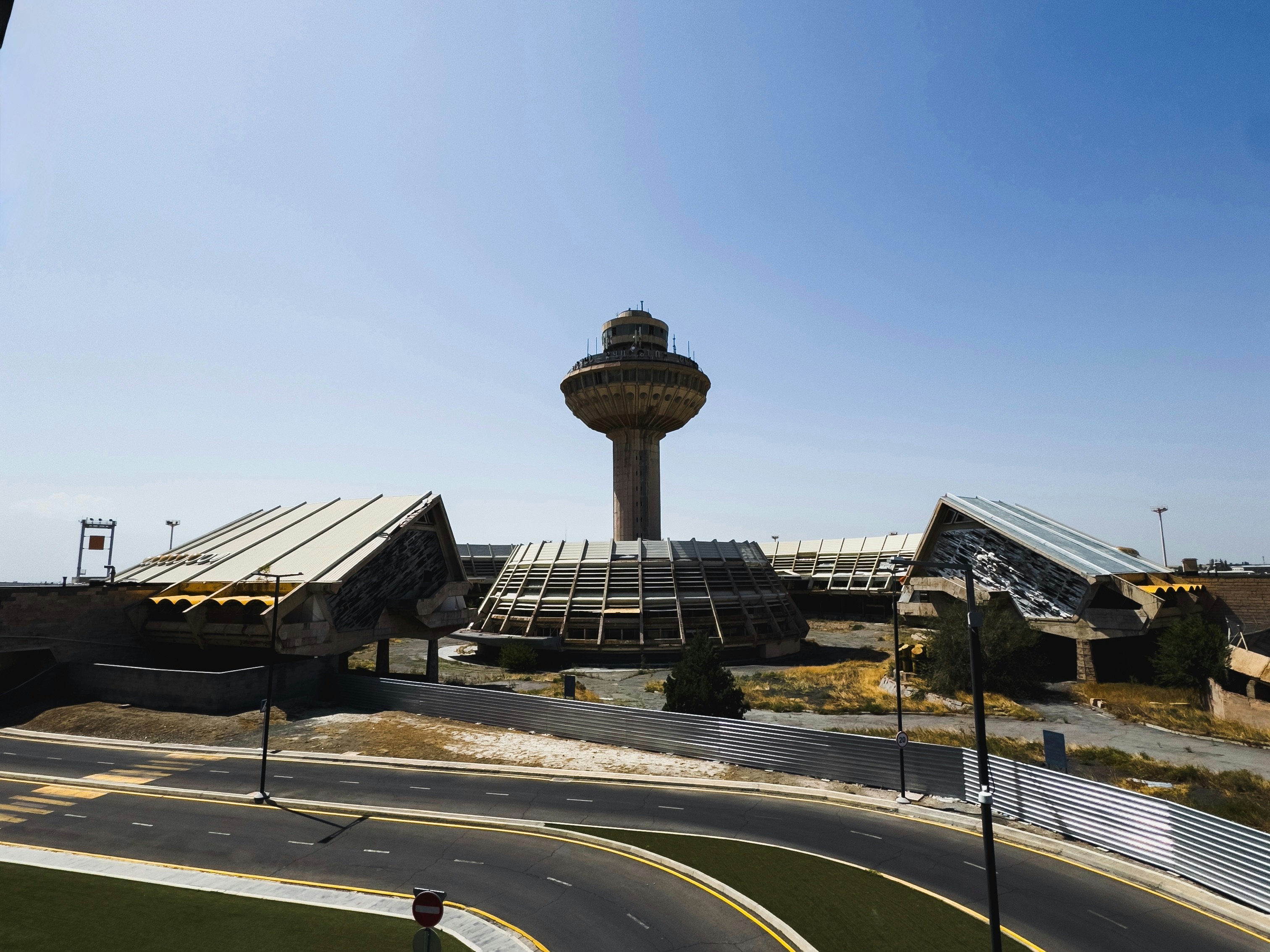 A view of an airport with a control tower in the background, 