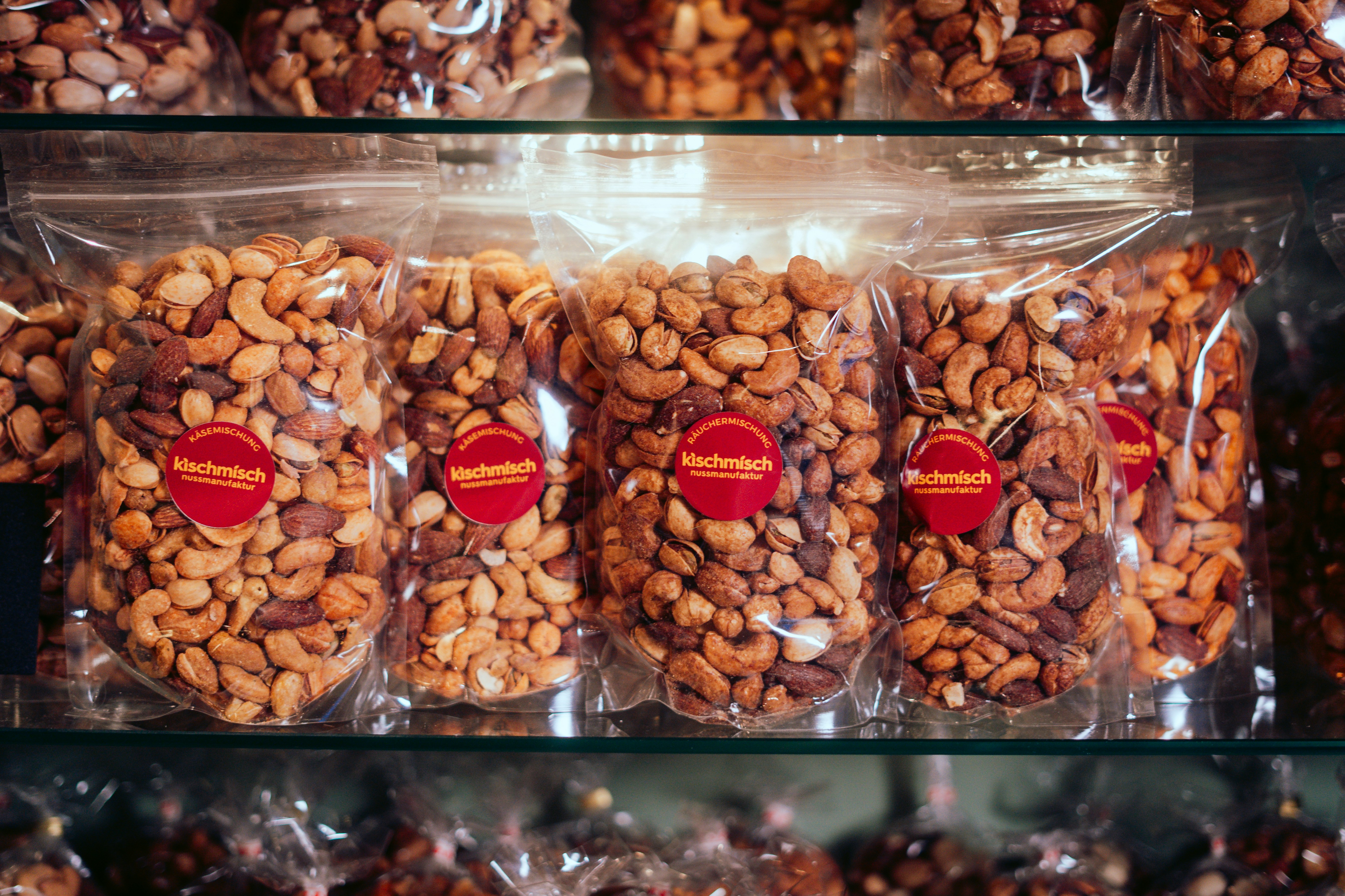 A display case filled with lots of chocolate covered nuts