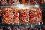 A display case filled with lots of chocolate covered nuts