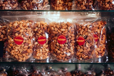 A display case filled with lots of chocolate covered nuts