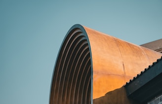 A tall building with a curved metal roof