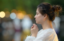 A woman in a white dress standing in the street