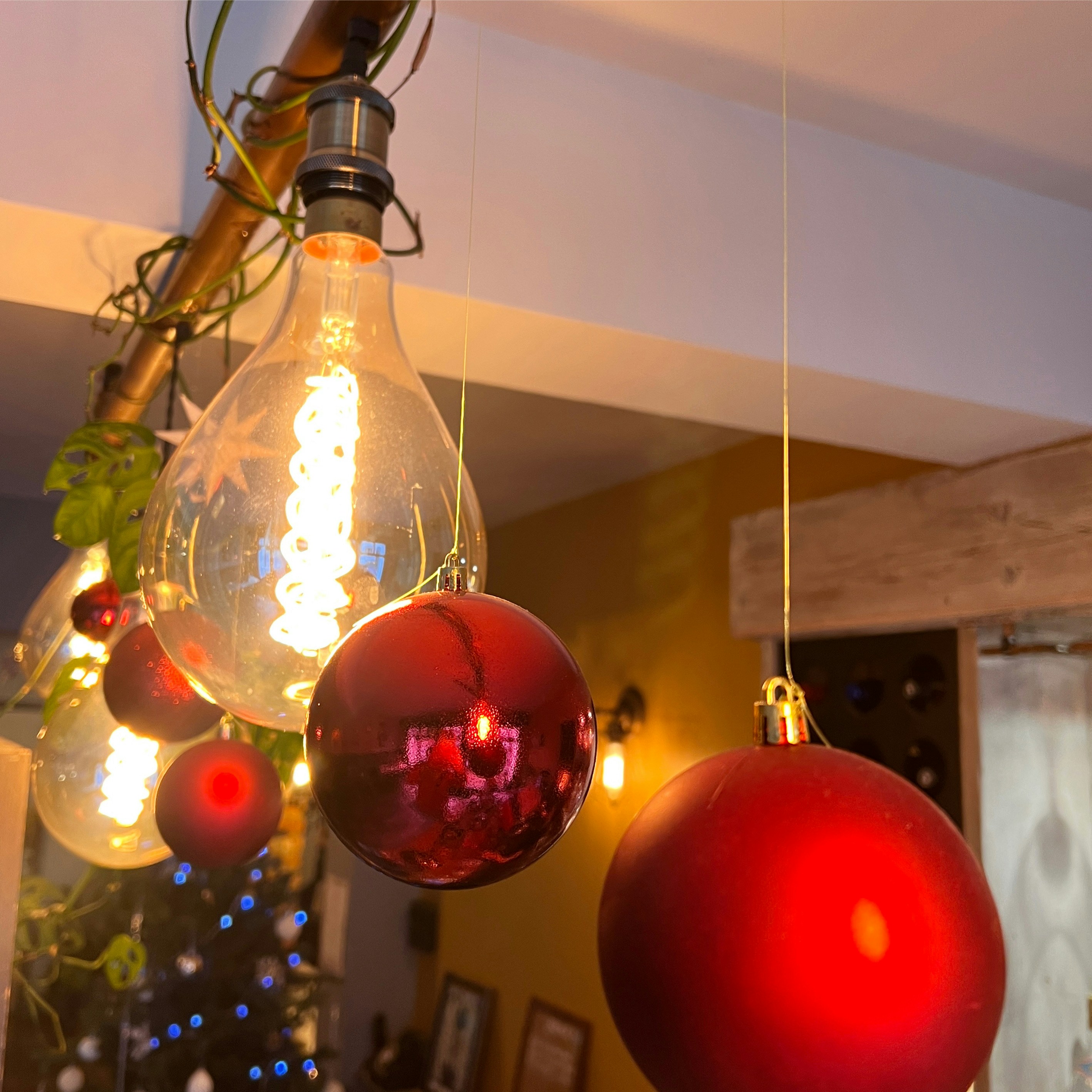 A group of christmas ornaments hanging from a ceiling