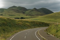 A curved road with hills in the background