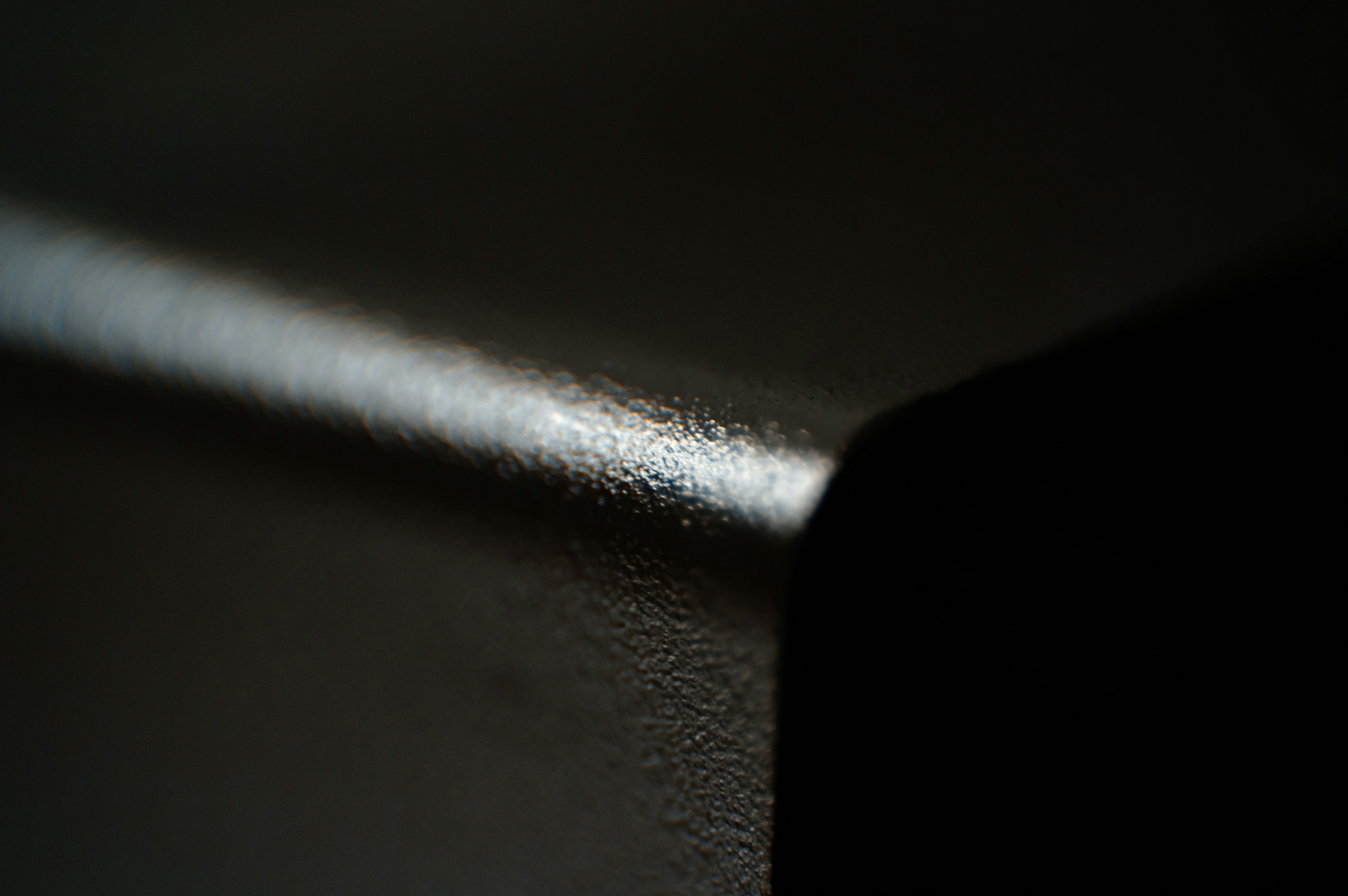 A close up of a black surface with a blurry background