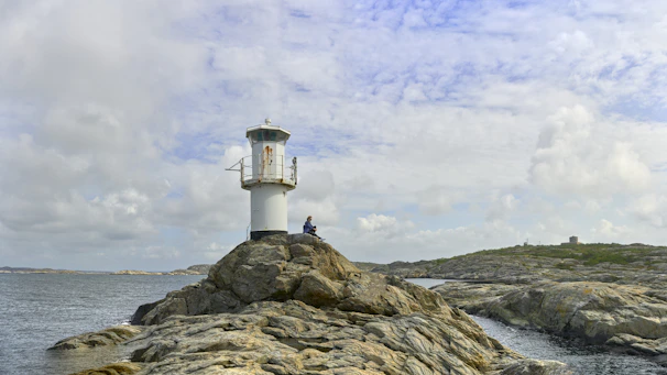 A lighthouse on top of a rocky outcropping