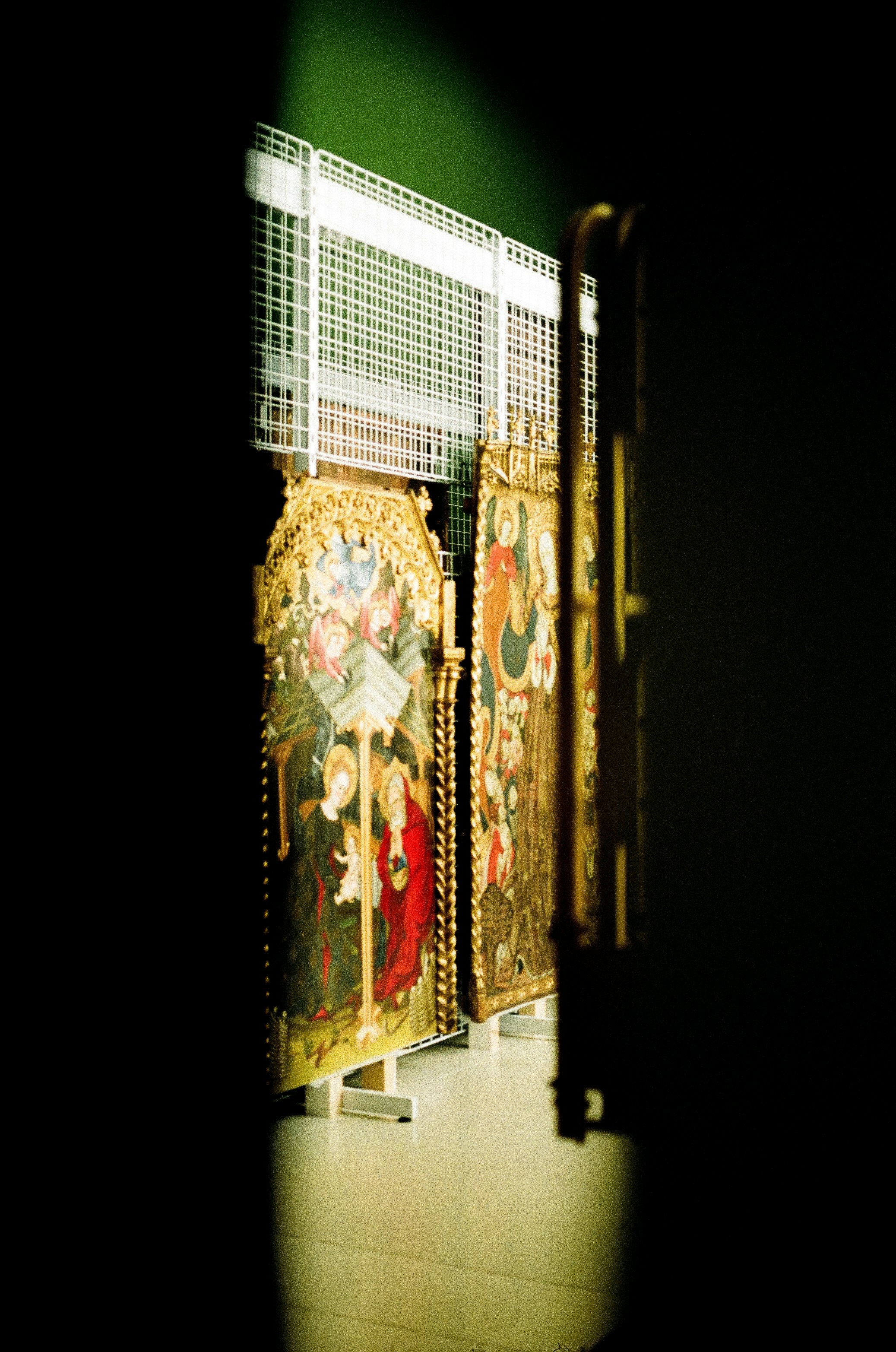 A room that has a bunch of paintings on the wall