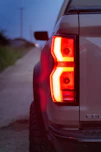The tail lights of a white pickup truck