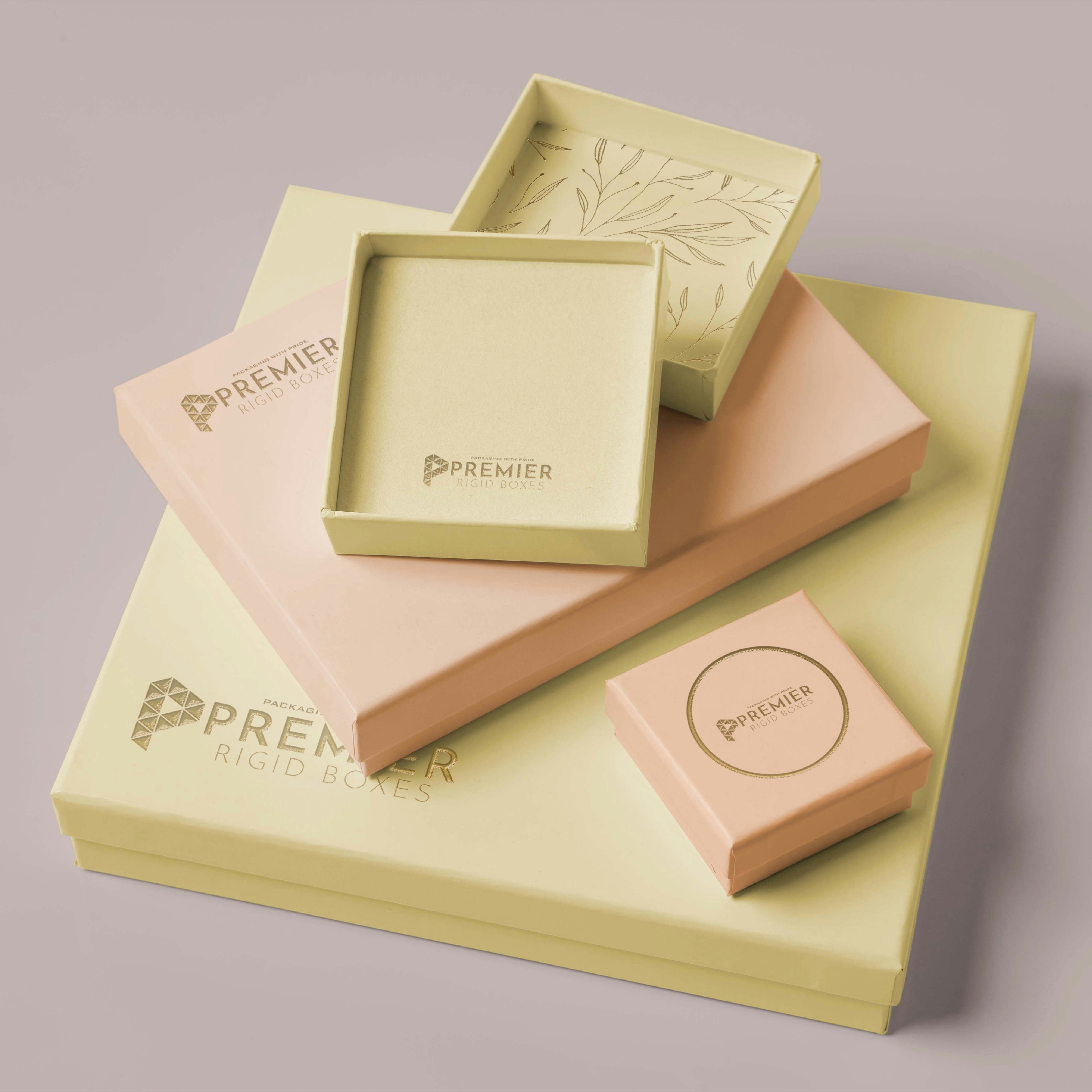 Assorted gift boxes with floral decorations on a bright white surface