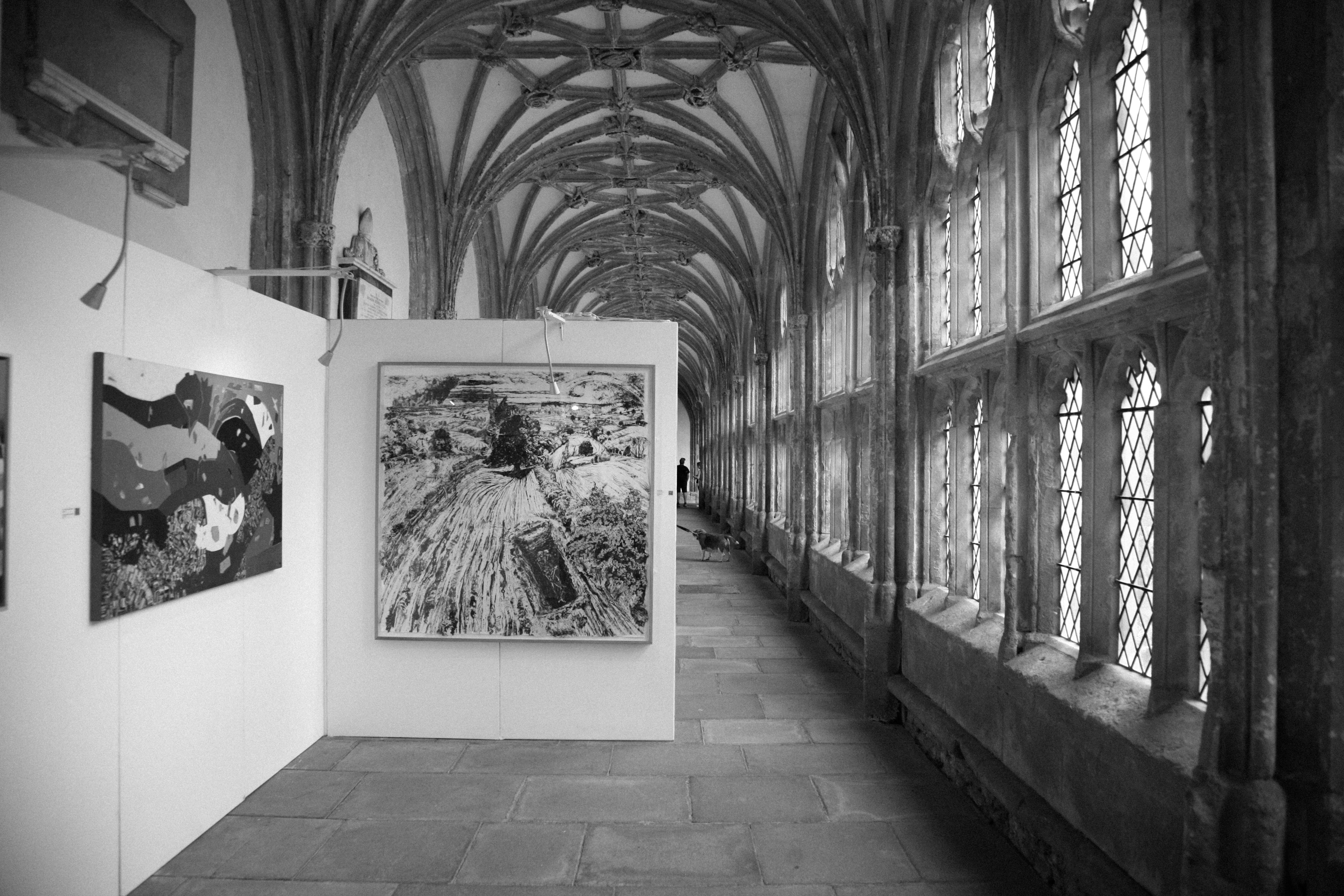 A black and white photo of a long hallway