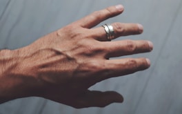 A person's hand with two rings on it