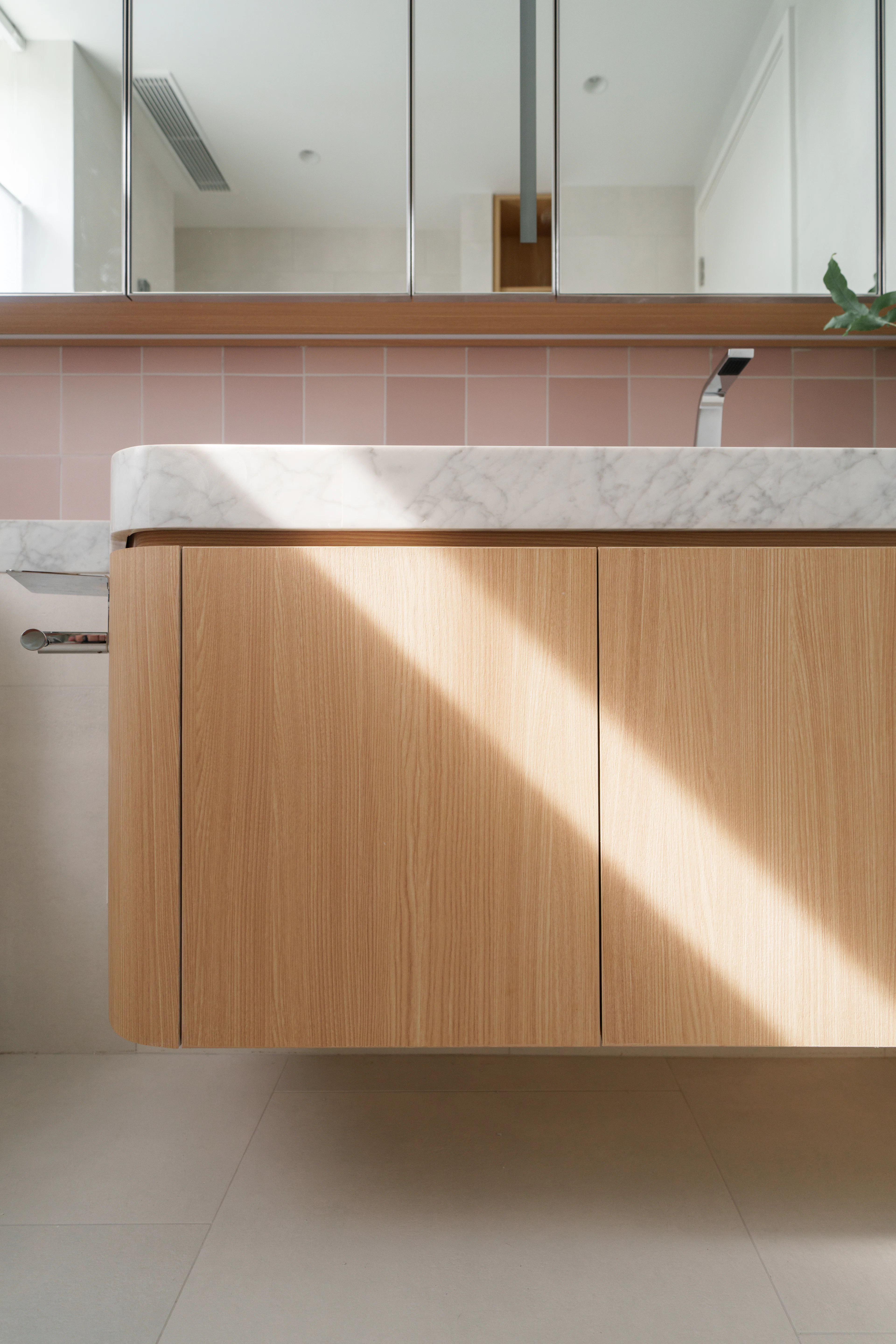 Close-up of an oak vanity with a stone top