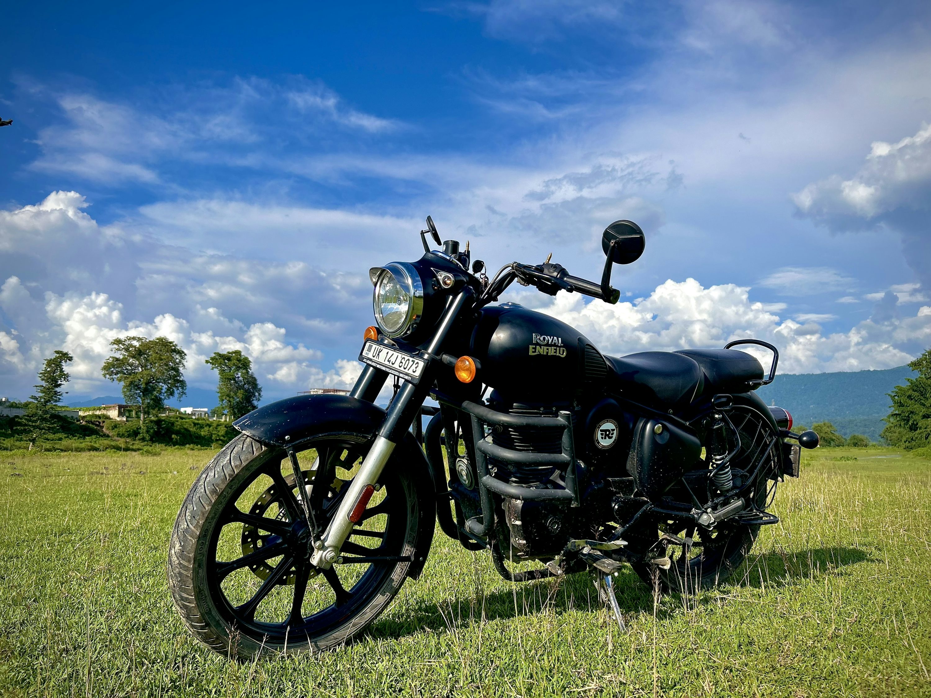 A motorcycle parked in a field of grass