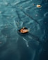 A small boat floating on top of a body of water