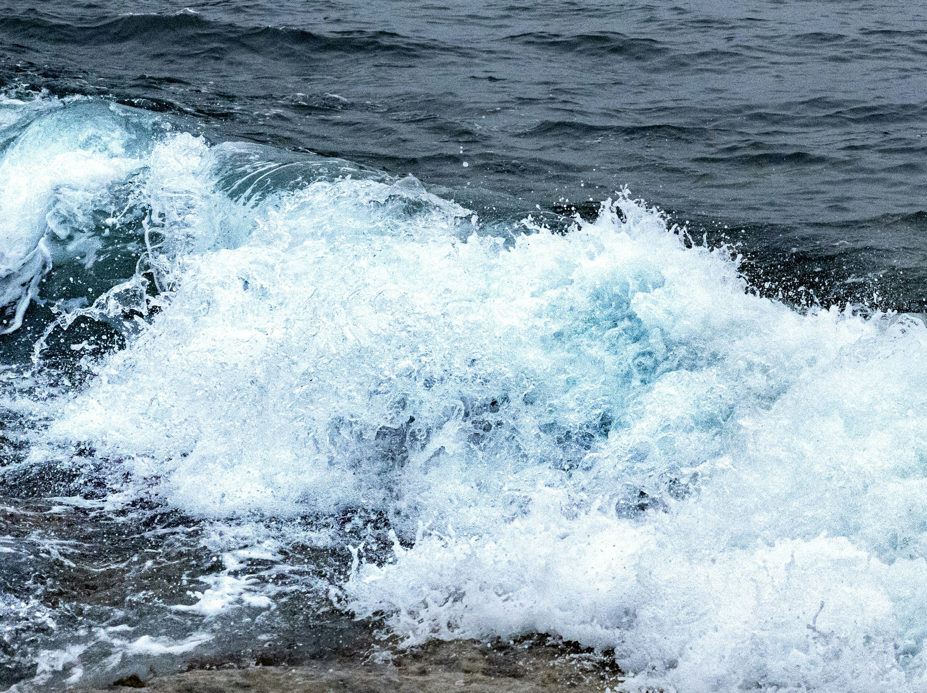 A person riding a surfboard on top of a wave