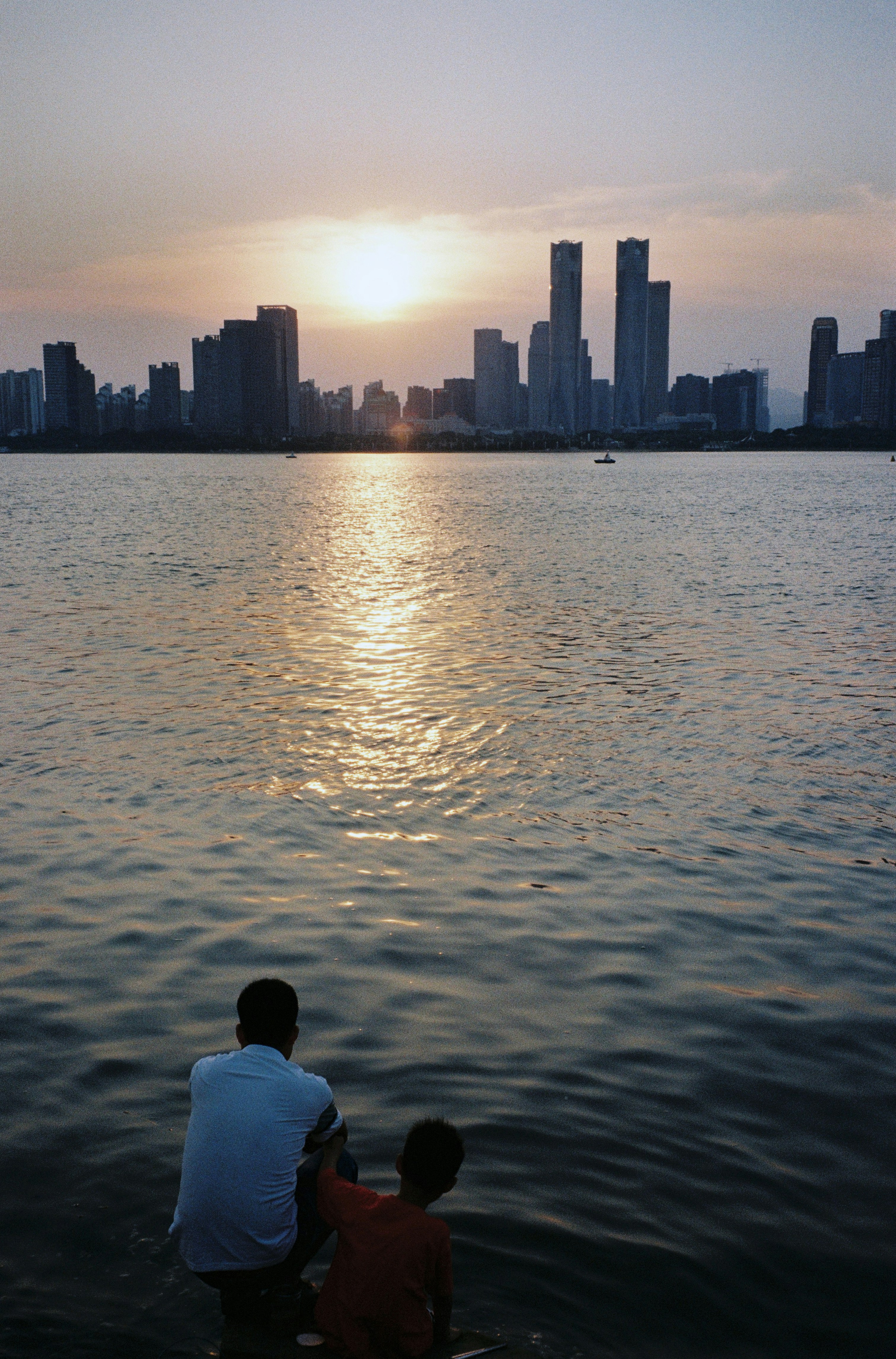 A couple of people that are sitting in the water