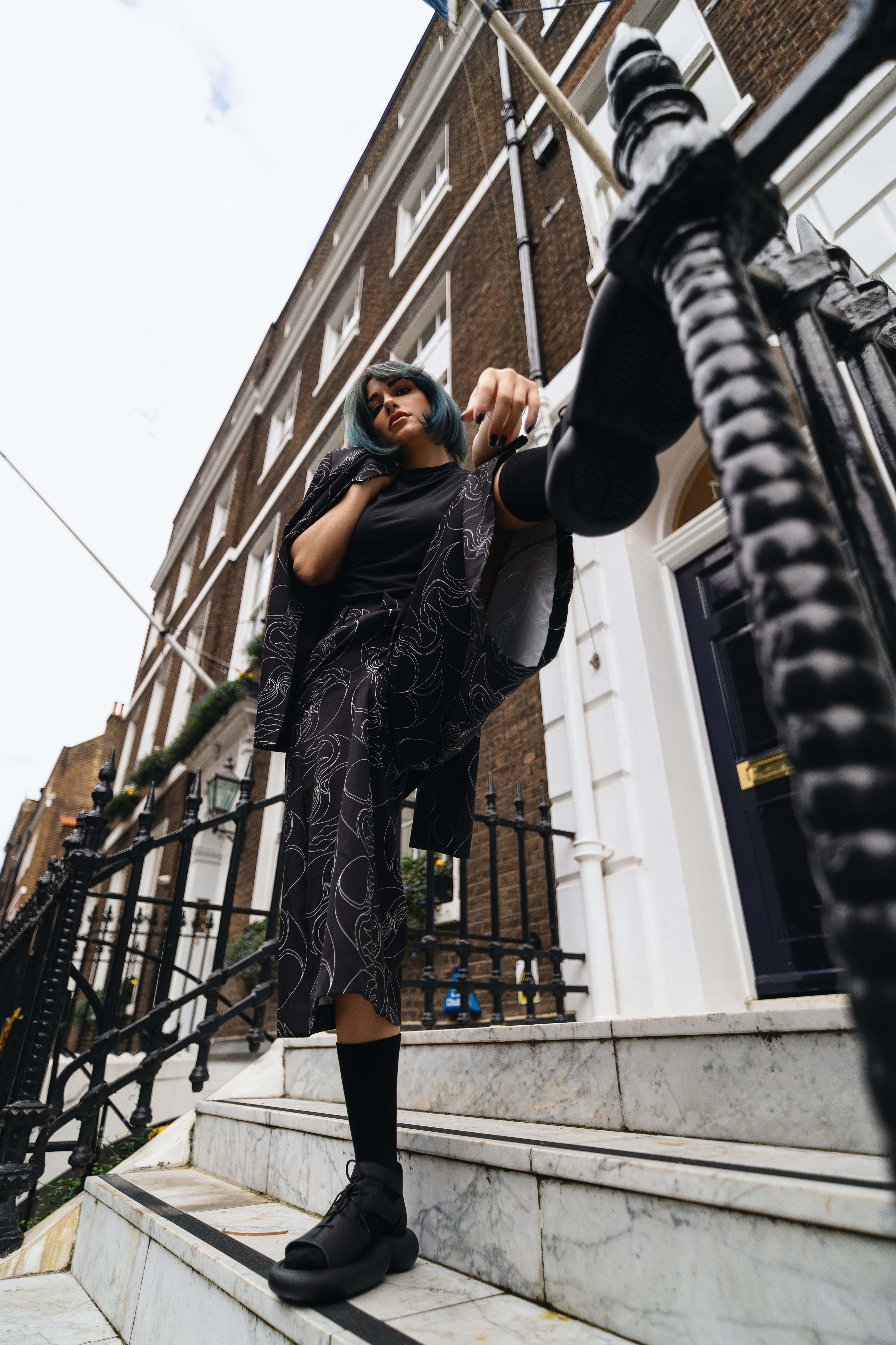 A woman standing on the steps of a building
