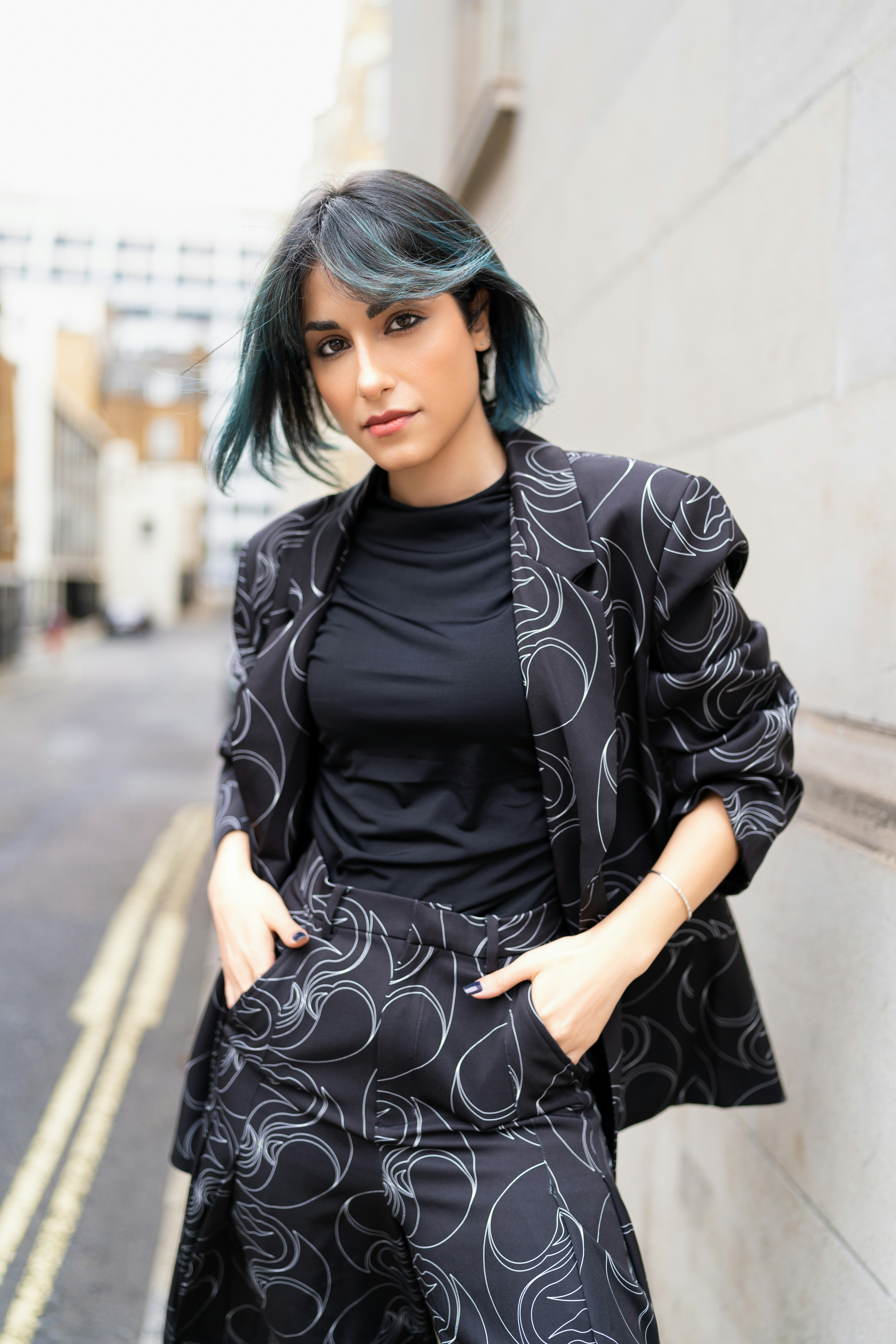 A woman with green hair standing next to a wall photo – Free London ...