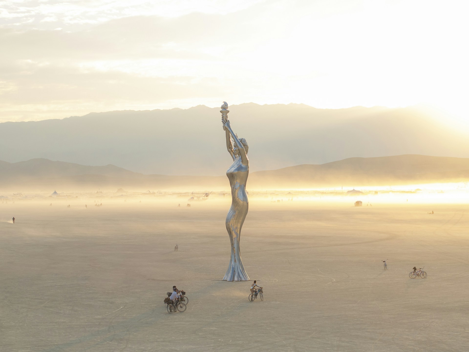A statue of a woman in the middle of a desert
