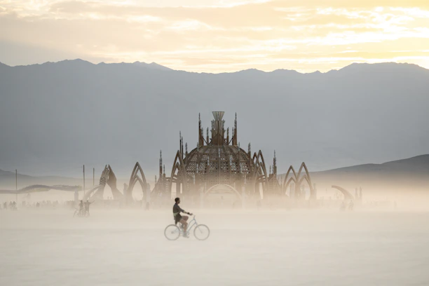 A person riding a bike on a foggy day