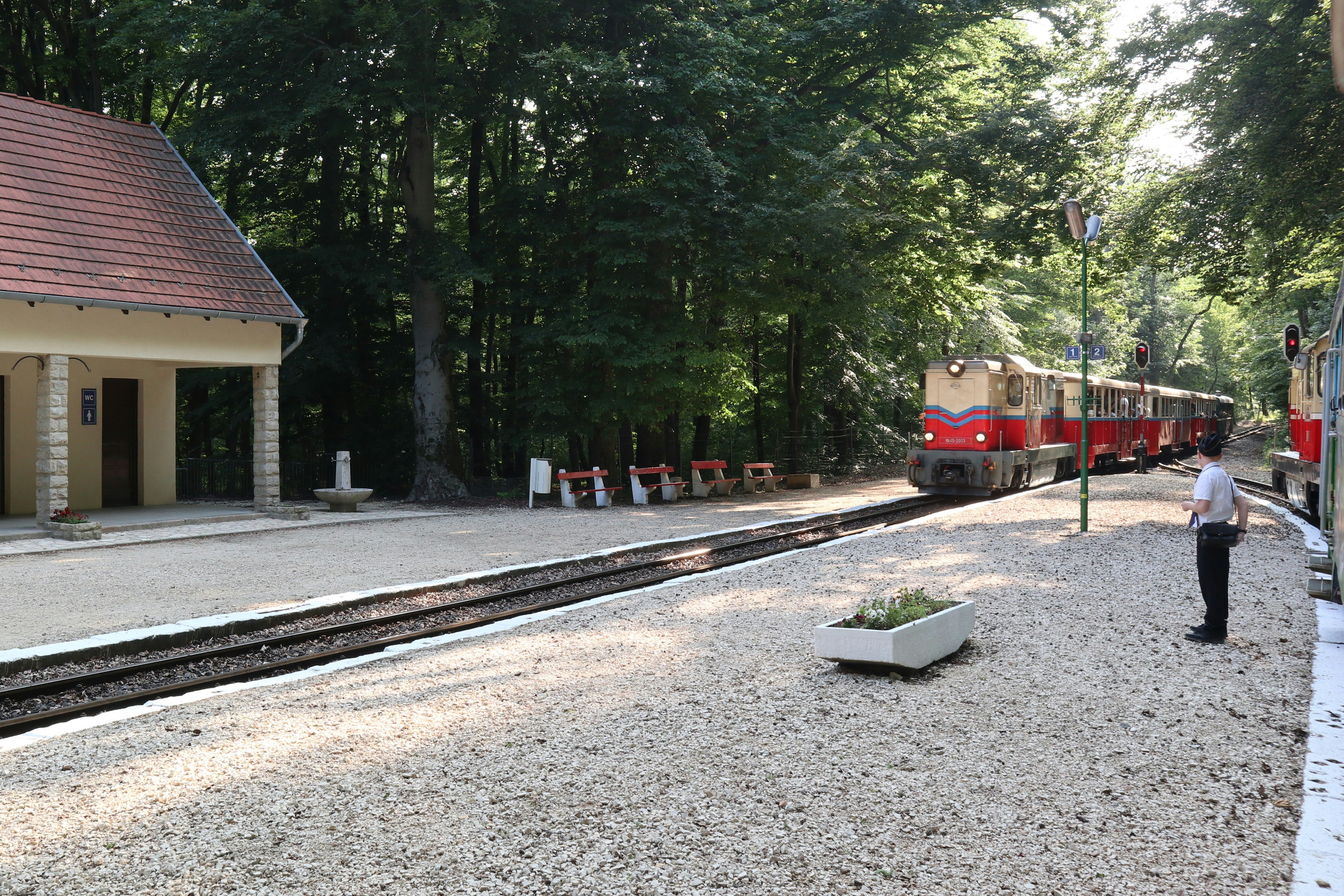 A train station with a train on the tracks