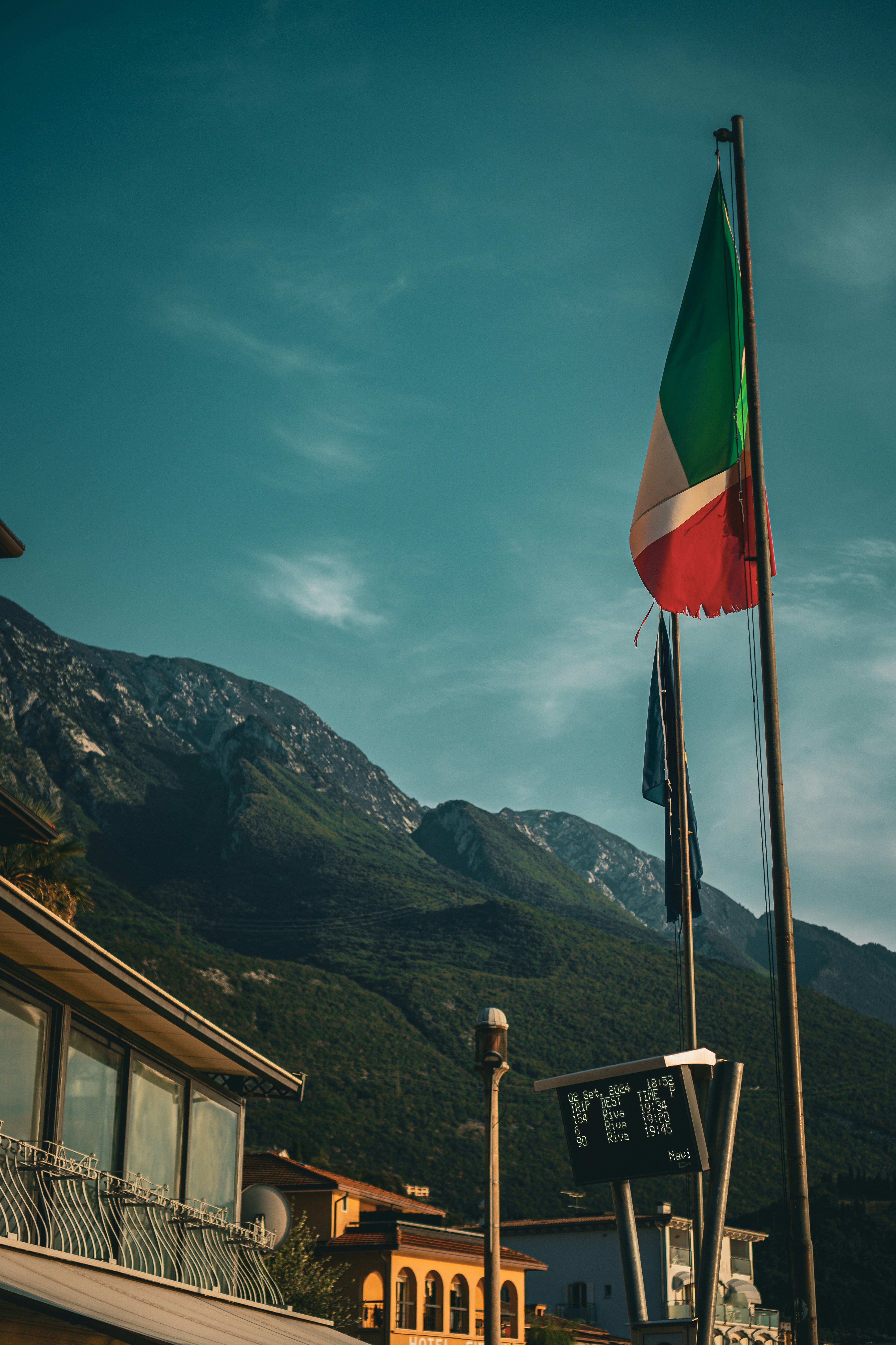 A flag is flying in front of a building