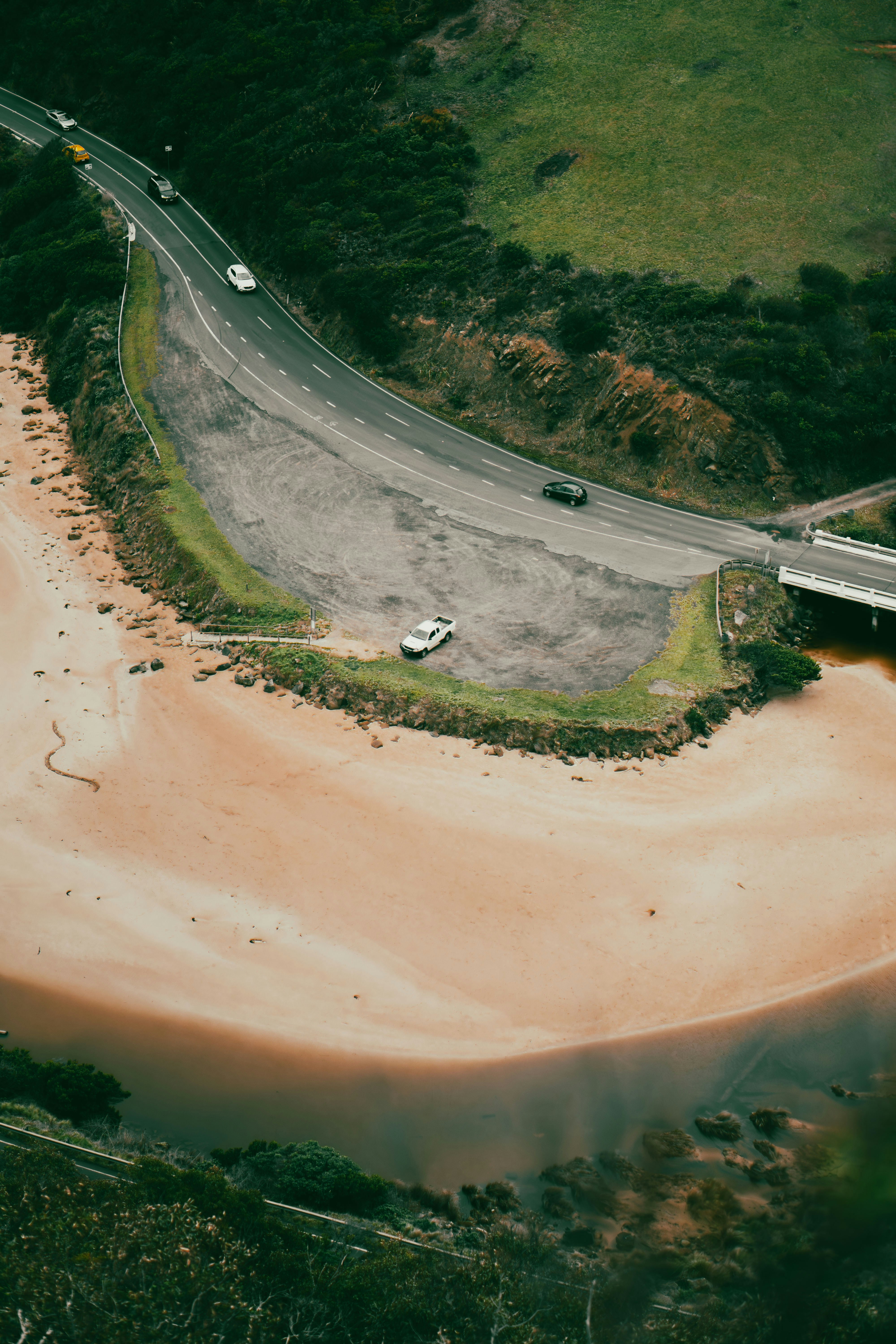 An aerial view of a beach and a road