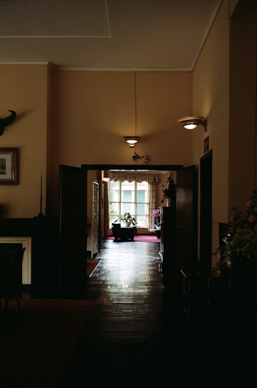 A dark hallway with a table and chairs